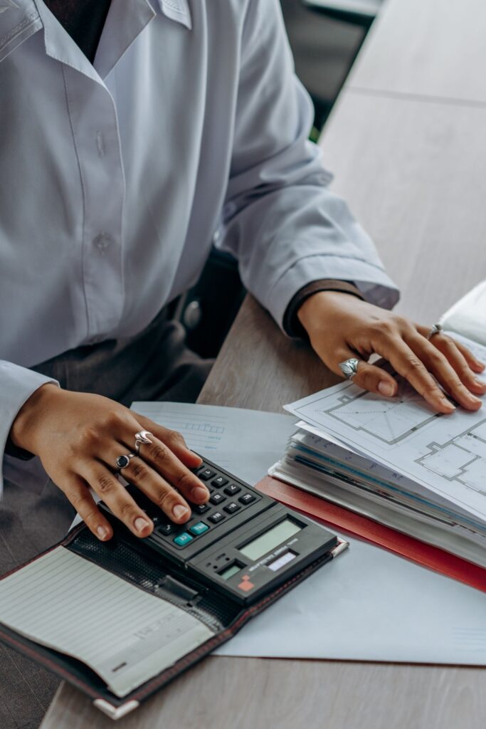 A person reviewing financial documents with a calculator